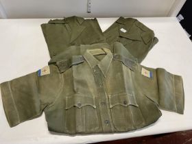 Three 1950s/60s army issue aertex shirts, one with patches for Far East Land Forces