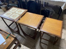 A set of three mid century nesting tables, the largest has a tiled top. No shipping.