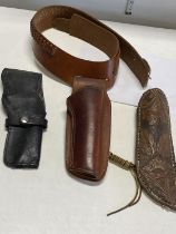 A vintage leather belt and holster and two leather hunting knife sheath's