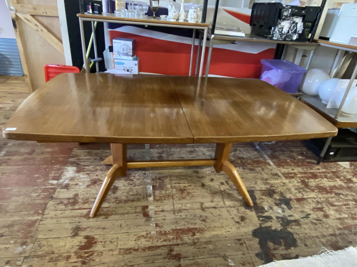 A vintage 19650's Gordon Russell Dining Table with extension piece, made from Rosewood, slight