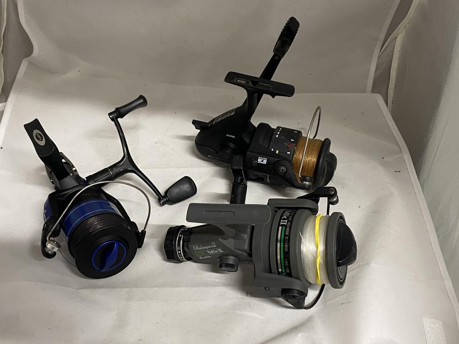 Three assorted carp fishing reels including Sheakspeare