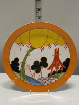 A commemorative Wedgwood plate in appreciation of Clarice Cliff and her Bizarre range
