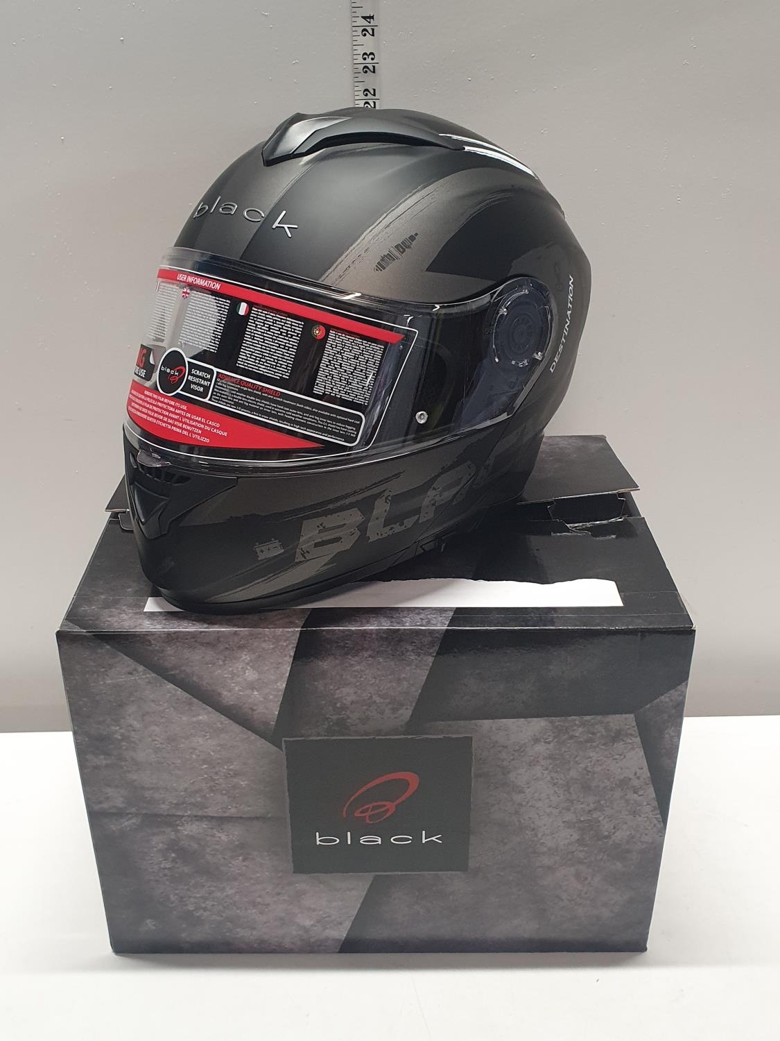 A New boxed black motorcycle helmet. Size XL