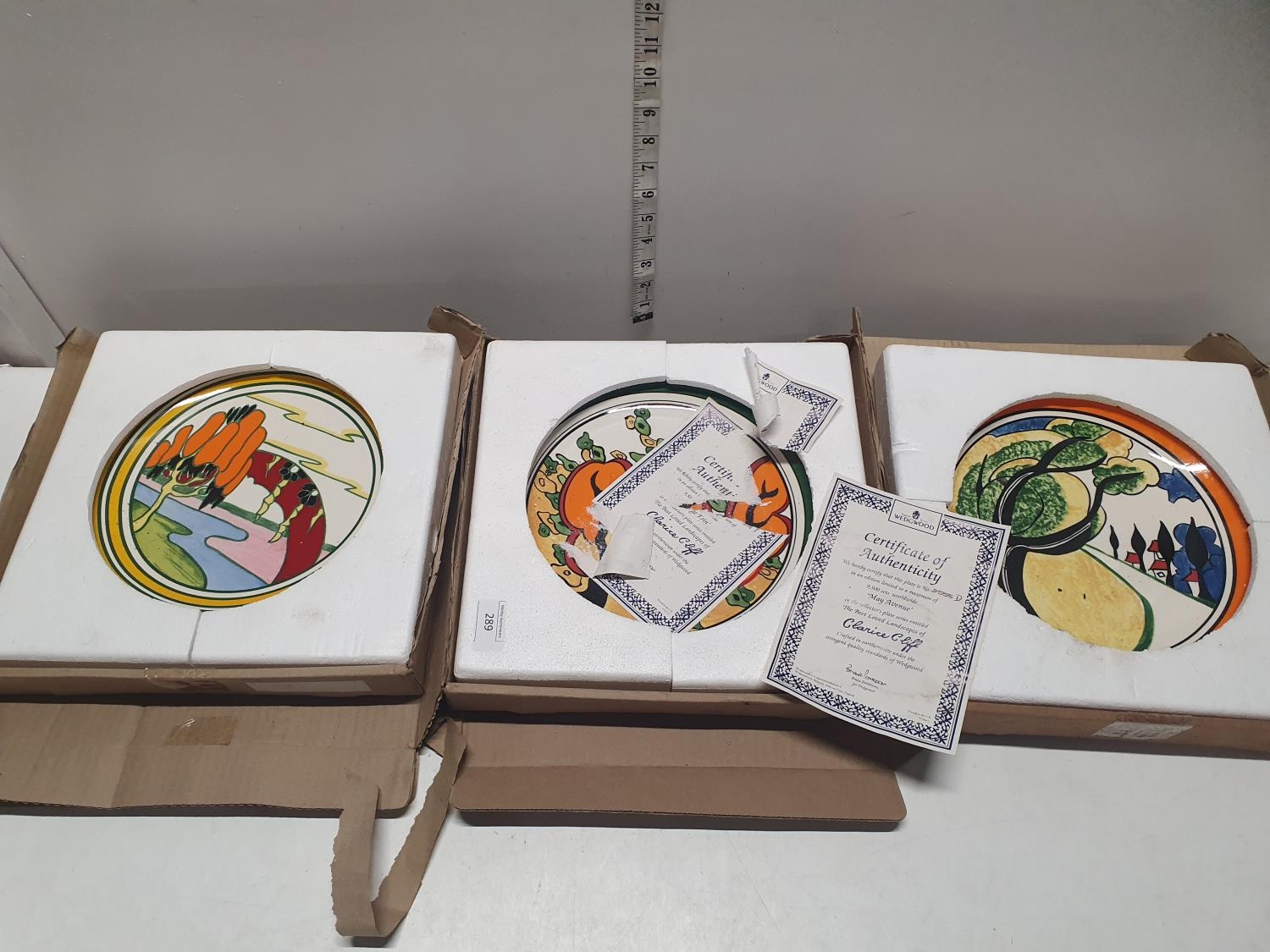 Three Wedgwood for Clarice Cliff, collectors plates with COA (one plate a/f)