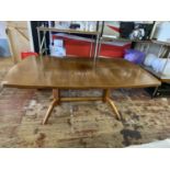 A mid century 1960's Gordon Russell Dining Table with extension piece, made from Rosewood, slight