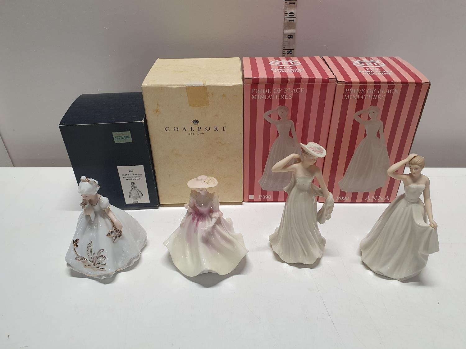 Four boxed ceramic figurines including Coalport.Shipping unavailable