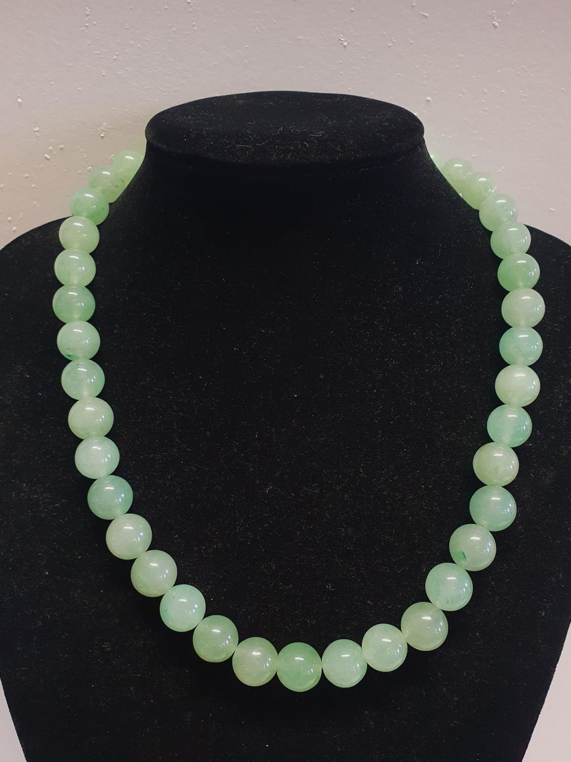 A green bead necklace possible Jade?