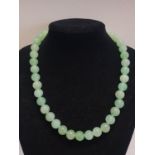 A green bead necklace possible Jade?
