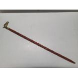 A brass topped walking cane. Shipping unavailable