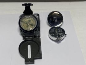 Two military style compasses.