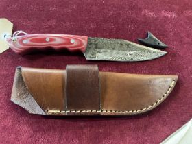 A hand forged Damascus steel bladed knife in leather sheath, over 18's only, UK post only