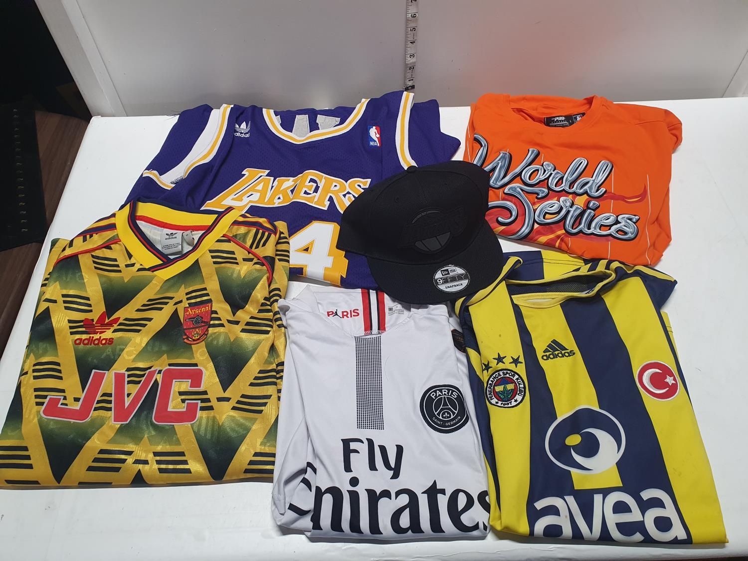 A selection of sports shirts including Lakers (unauthenticated)
