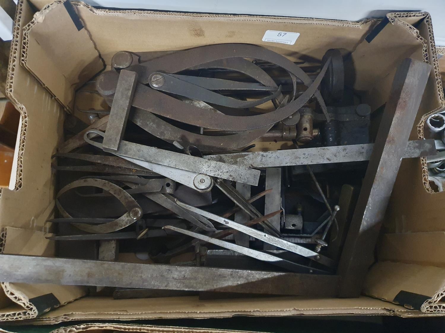 A job lot of measuring callipers, set squares and steel rulers. Shipping unavailable
