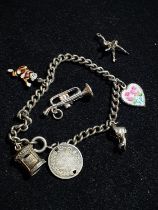 Silver bracelet and white metal charms.