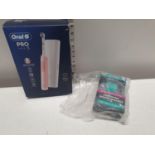 A boxed as new Oral B electric toothbrush and a dental guard (untested)