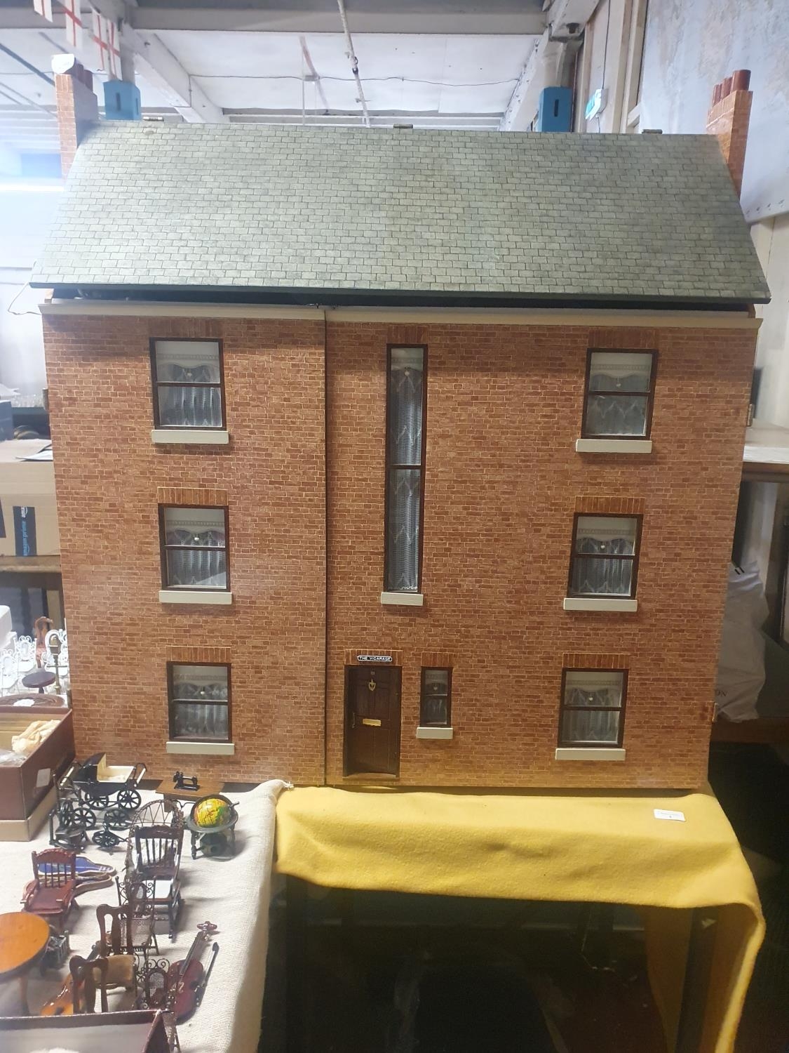 A large vintage dolls house. complete with furniture for each room. 87x95x44cm .Shipping unavailable