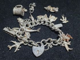A silver bracelet with white metal charms. weight 95.66g