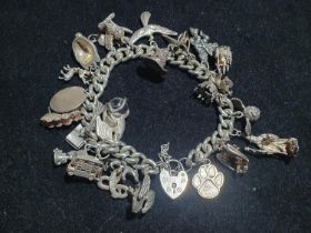 A 925 silver bracelet with large selection 925 and white metal charms (Harry Potter themed).
