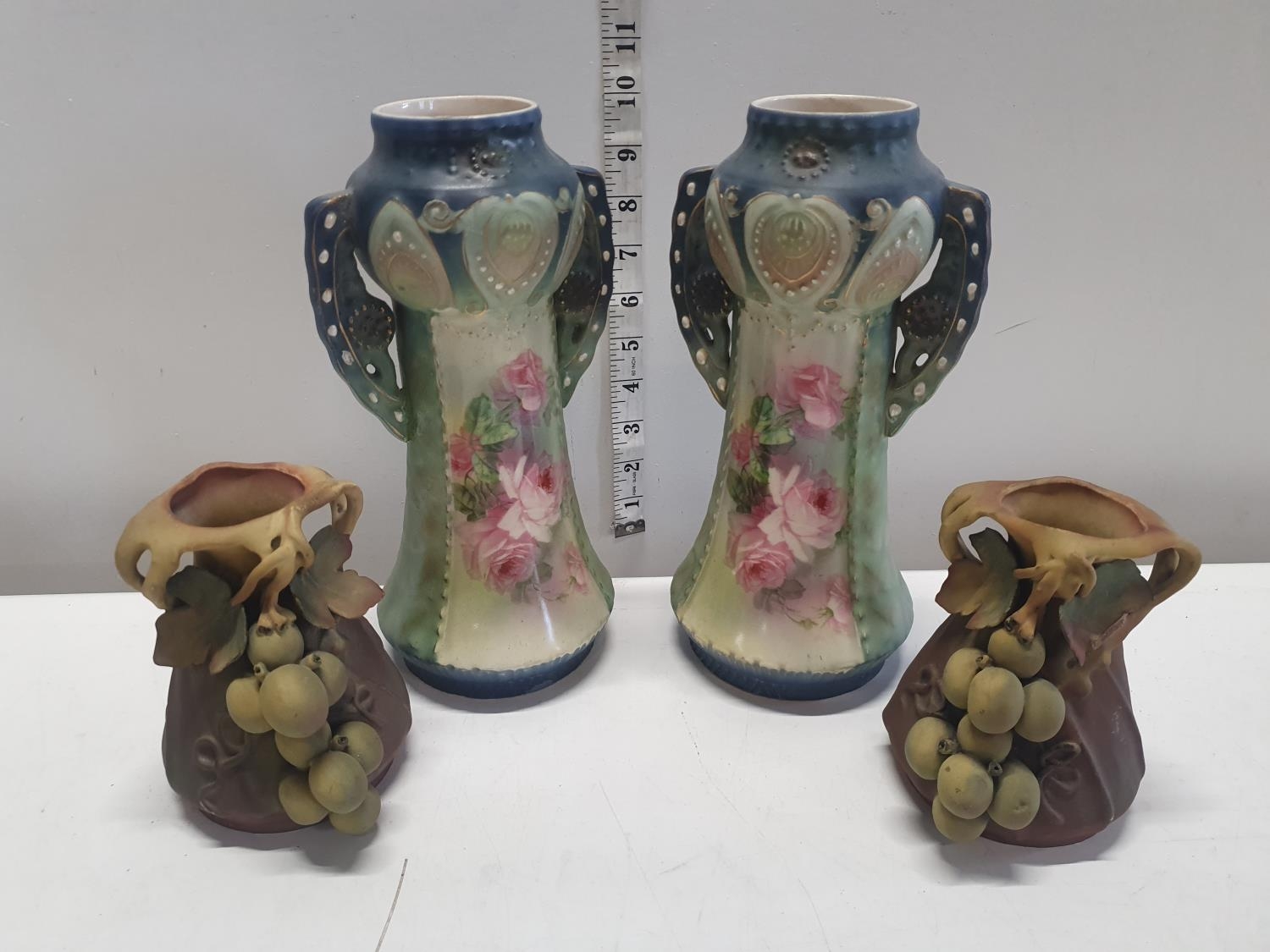 Two pairs of hand painted ceramic vases.Shipping unavailable