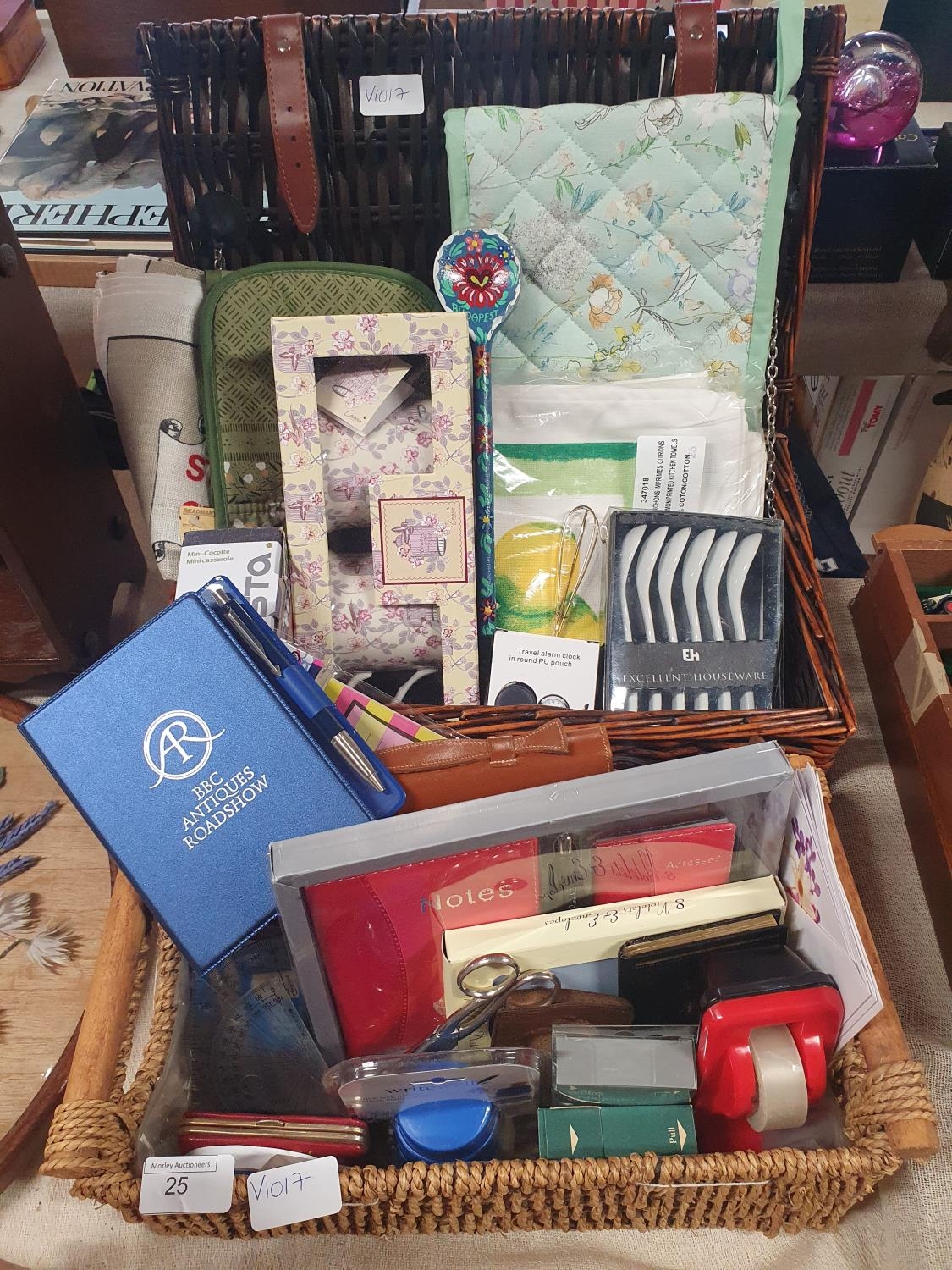 Two baskets of new items including kitchenalia and stationery, shipping unavailable