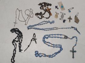 A selection of rosary beads and religious pendants
