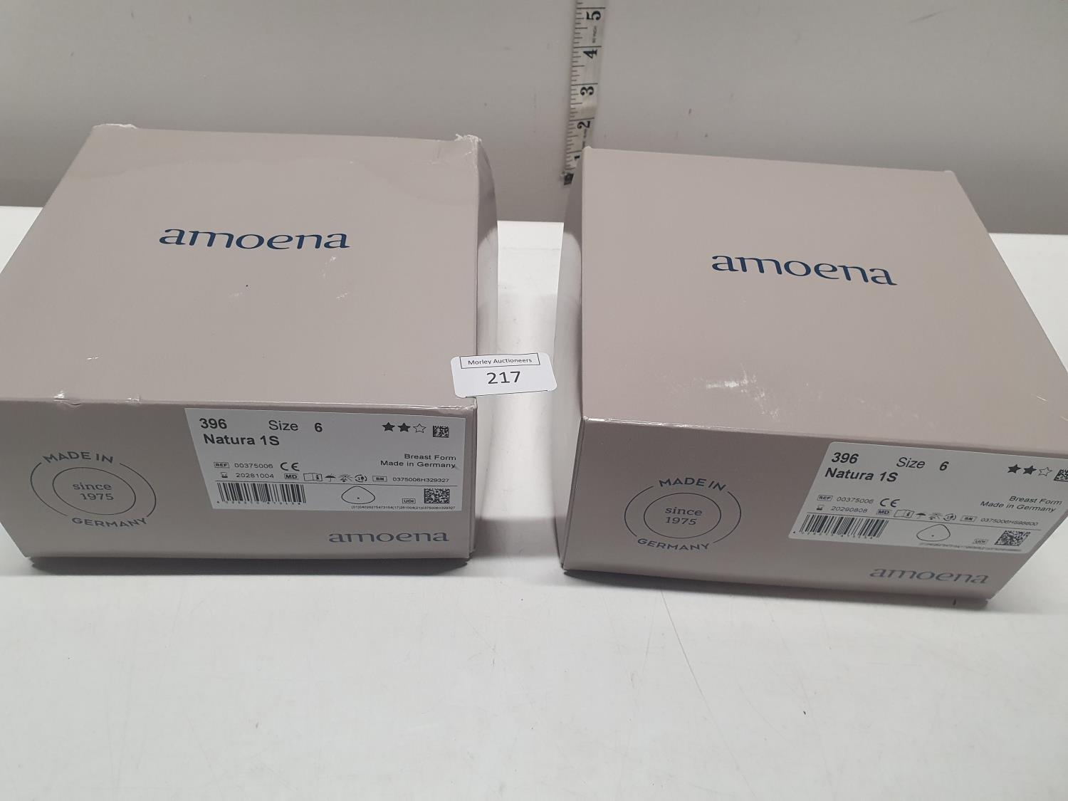 A pair of boxed amoena female prosthetics