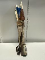 A selection of hand made Native American Indian style arrows and two arm protectors together in a