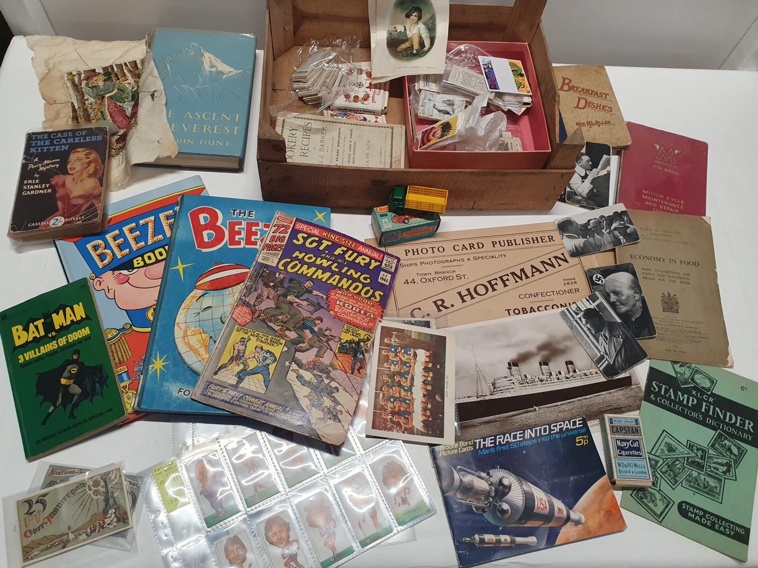 An assortment of vintage cigarette cards and books. Shipping unavailable