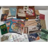 An assortment of vintage cigarette cards and books. Shipping unavailable