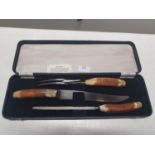 A cased Horn handled carving set. Shipping unavailable