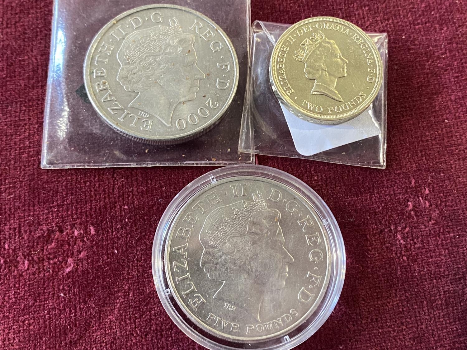 A collectable £5 and £2 coin and one other