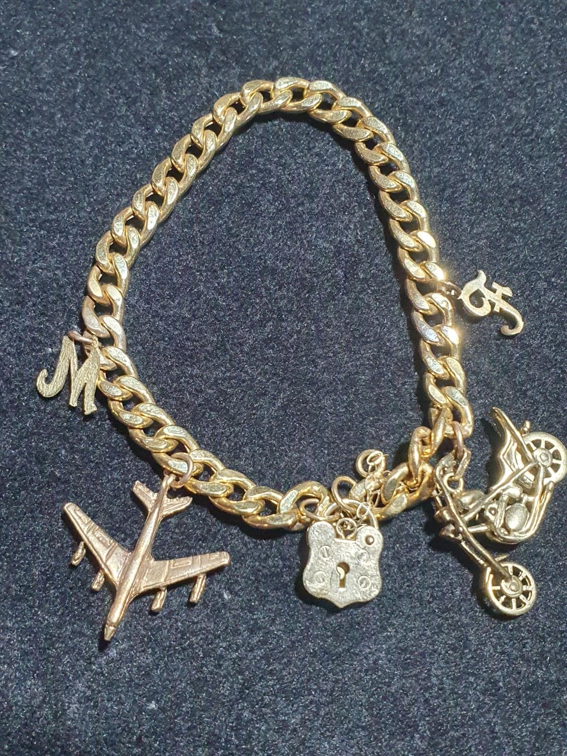 A 9ct gold bracelet with yellow metal charms. Gross weight 10.6g