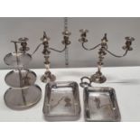 A selection of silver plated wares including candelabras and cake stands. Shipping unavailable