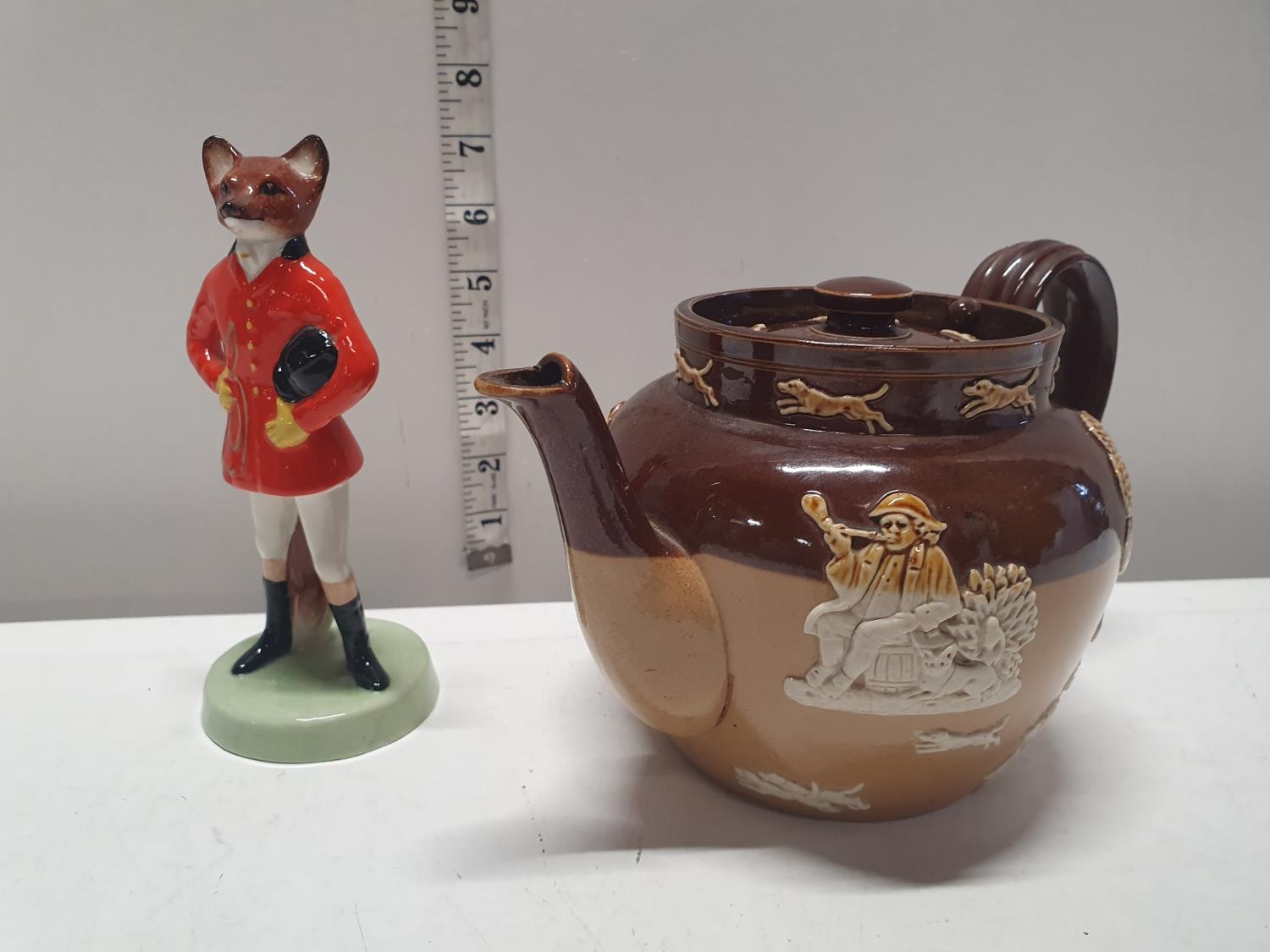 A Royal Doulton teapot and one other ceramic figure, shipping unavailable
