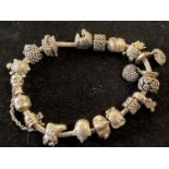 A silver Pandora bracelet with charms gross weight 77.48g