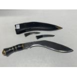 A vintage Kukri knife with two smaller knives in leather scabbard