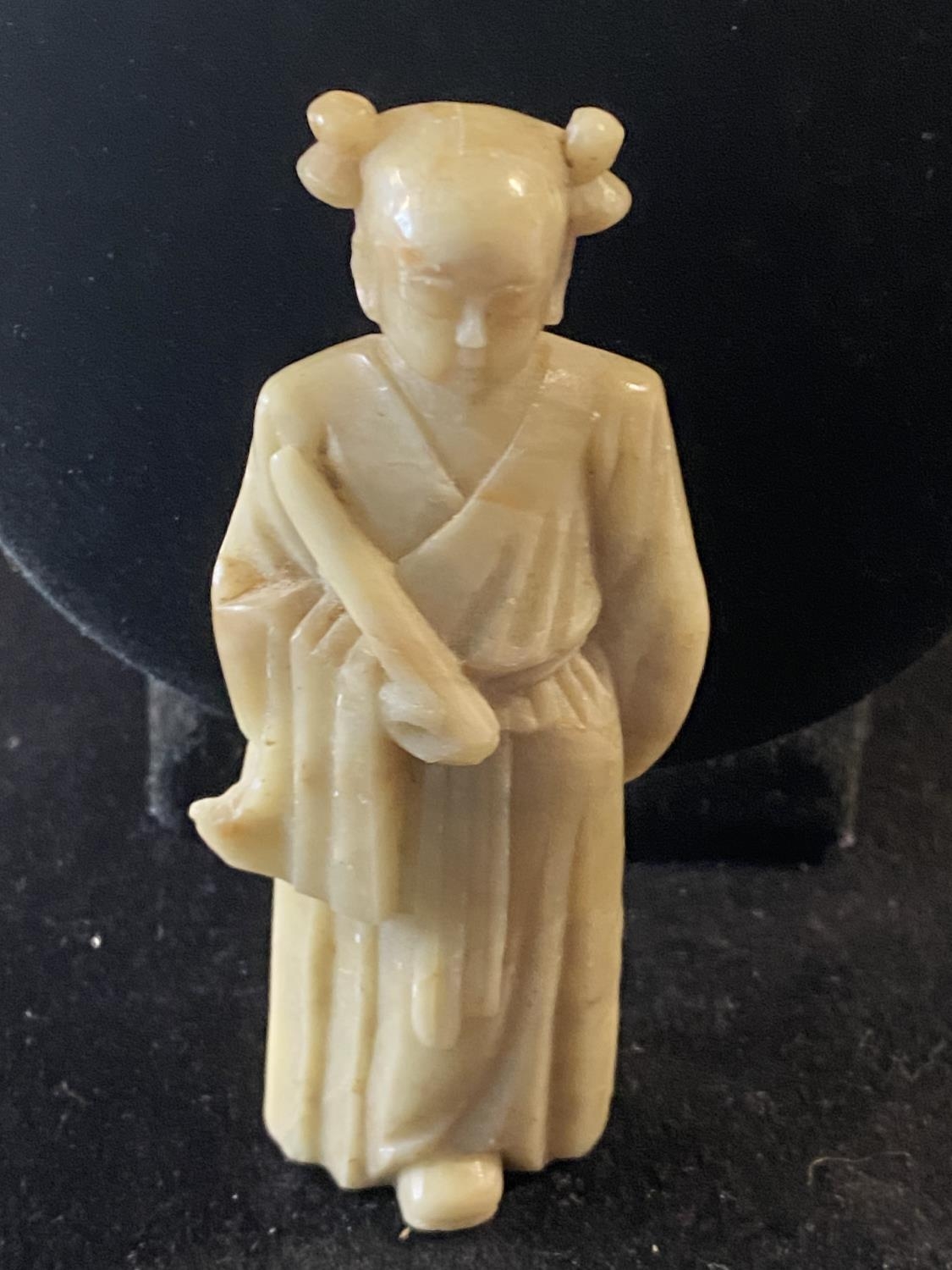 A Chinese soap stone carving of a female