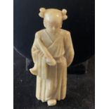 A Chinese soap stone carving of a female