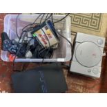 Two games consoles a PS1 and a PS2 with controllers and games (untested)