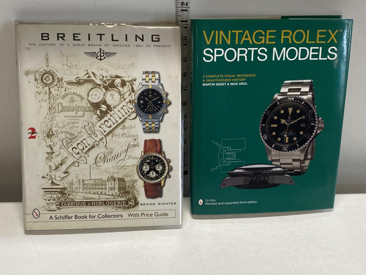 Two hardback Schiffer collectors books one for vintage Brietling watches and the other for vintage
