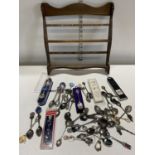 A job lot of assorted collectors spoons and display rack.Shipping unavailable