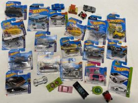 A box of assorted boxed Hot Wheels models and other