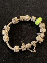 A silver Pandora bracelet with charms gross weight 59g