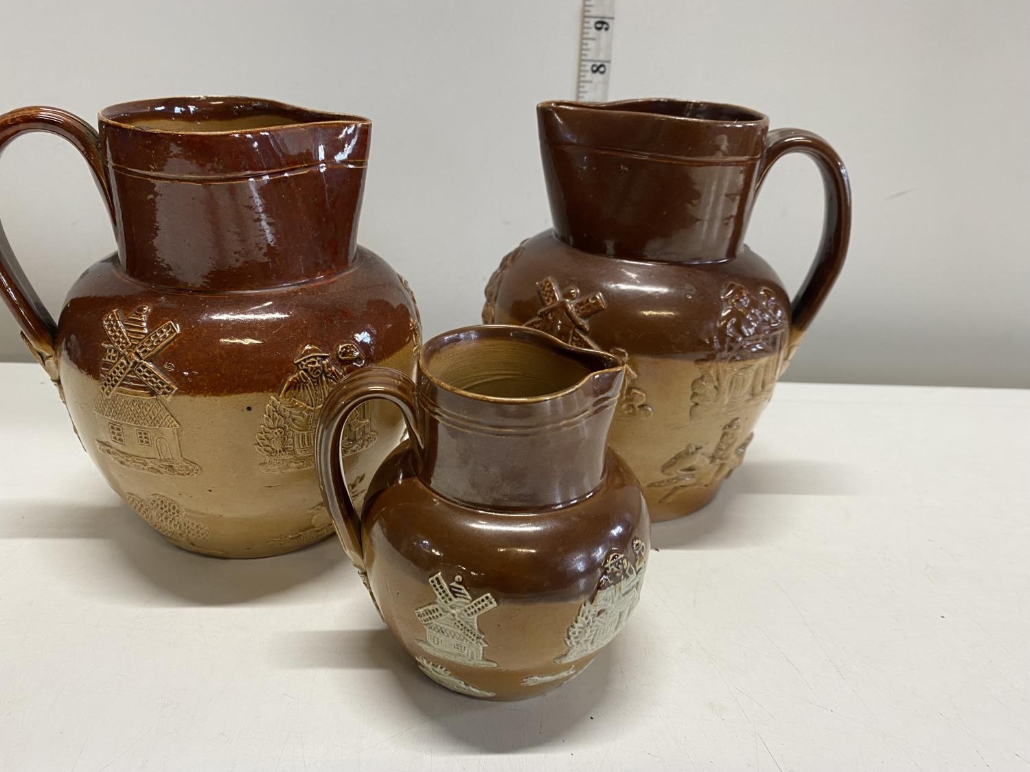 Three Royal Doulton salt glazed jugs, shipping unavailable