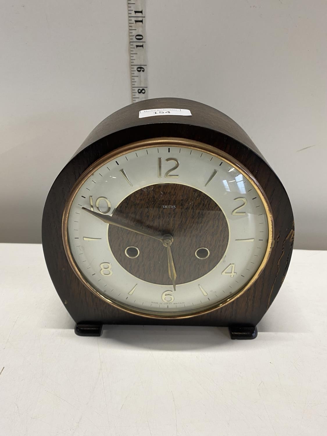 A wooden cased Smiths mantle clock with key and pendulum, shipping unavailable