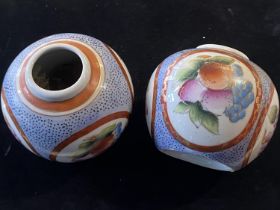 A pair of Chinese vases with hand applied fruit decoration