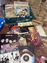 A job lot of assorted mixed genre LP and single records, shipping unavailable