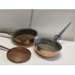 Three antique copper and cast metal pans