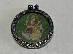 A silver framed hand painted Persian pendant