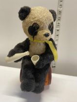 A vintage mechanical drinking panda